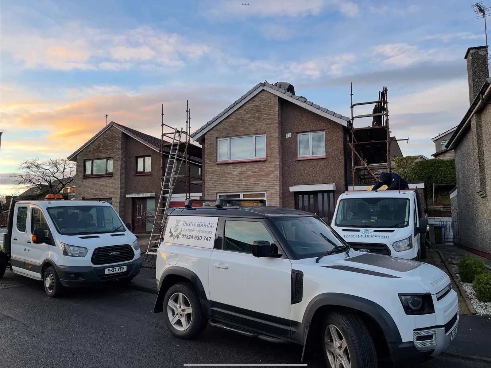 Thistle Roofing Ltd van and vehicle fleet on site at dusk