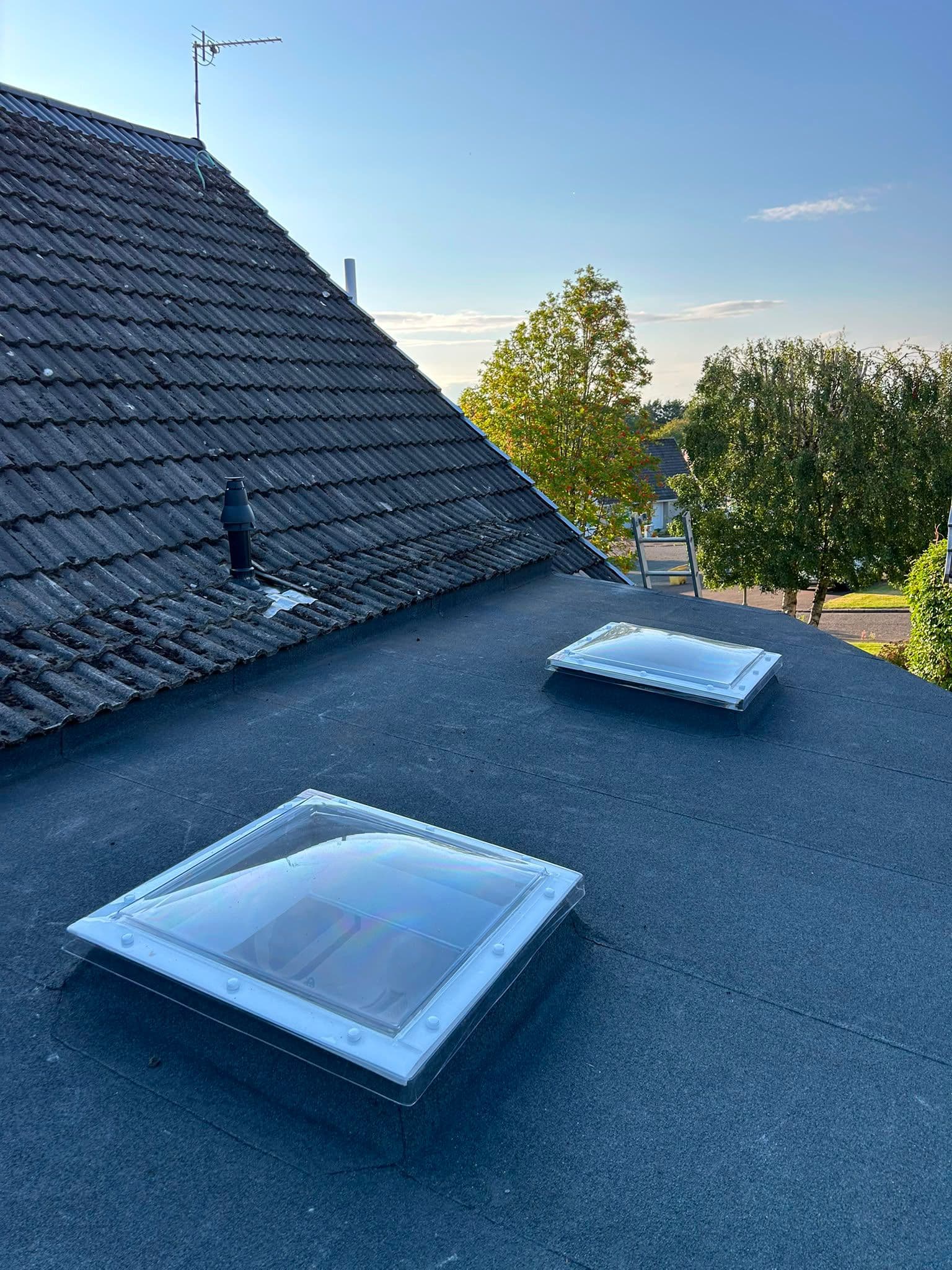 New felt flat roof with dome rooflights fitted over a conservatory
